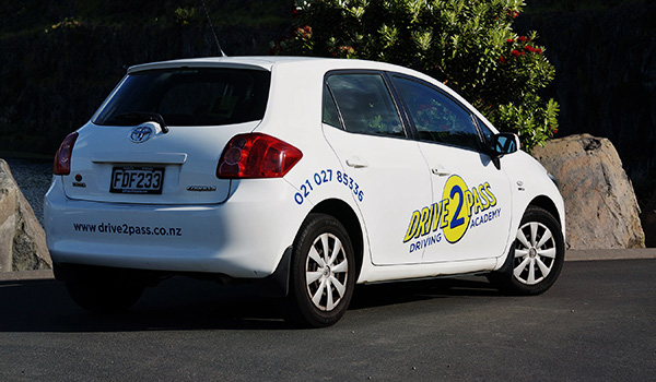 Professional Auckland driving instructor teaching student in modern automatic vehicle